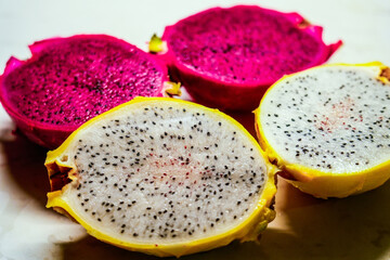 dragon fruit pitahaya red purple and yellow fruits cut in half