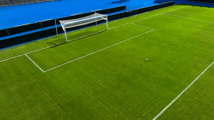 Aerial closeup of the penalty area on an empty grass soccer field. Here a penalty is taken in a soccer game.