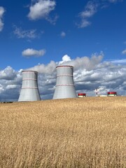 cooling towers of a nuclear power plant on a sunny day against a blue sky