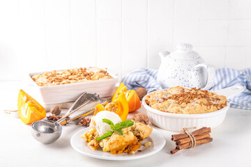 Homemade autumn pumpkin crisp cobbler, pumpkin crumble pie with crunchy dough topping in baking...