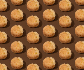 Food pattern with Brazilian cheese buns on the brown background, minimalism with hard shadows