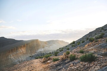 A rugged mountainous terrain with a trail leading downhill
