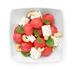 Delicious watermelon salad with feta cheese, cashew nuts and spices in bowl isolated on white, top view
