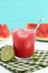 Tasty watermelon drink in glass, fresh fruits and mint on white table