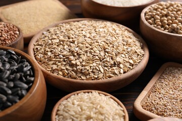 Different types of cereals, seeds and legumes on table, closeup