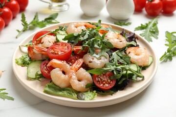 Delicious shrimp salad with vegetables on white marble table, closeup