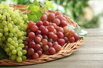 Fresh ripe grapes on wooden table, closeup