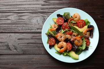 Delicious shrimp salad on wooden table, top view. Space for text