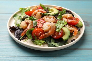 Delicious shrimp salad on light blue wooden table, closeup