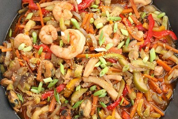 Stir-fry sea food in wok, top view