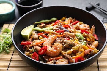 Stir-fry sea food served on grey table, closeup