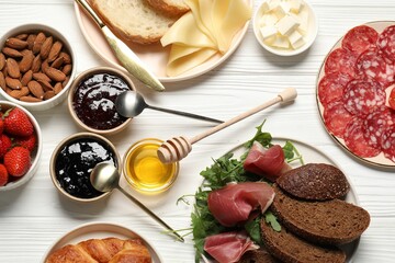 Different tasty food served for brunch on white wooden table, flat lay