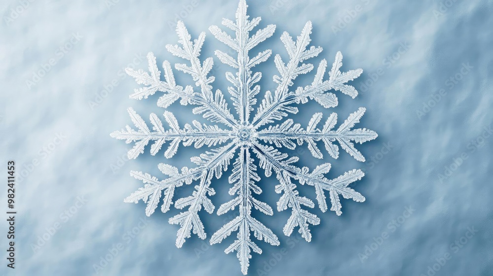 Poster isolated snowflake on a soft blue background, showcasing intricate patterns and delicate beauty of w