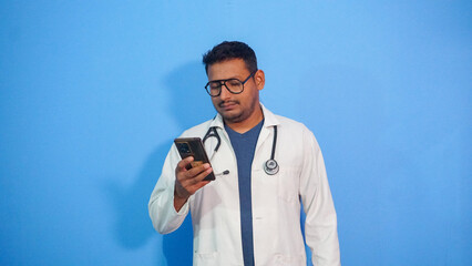 A male doctor using his mobile with a stethoscope. 