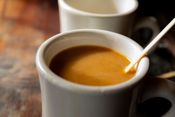 Close of coffee and cream in a white mug 