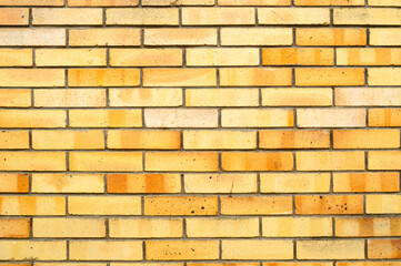 Brick wall background - new yellow bricks wall pattern. Texture brick wall of yellow color, brick wall surface