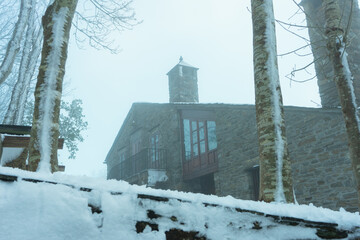 Snowy Stone House in Fog