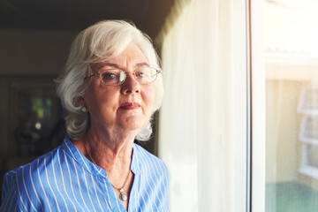 Glasses, happy and portrait of senior woman by window in home with positive attitude for retirement. Smile, memory and elderly female person from Ireland with dementia remembering past at house.