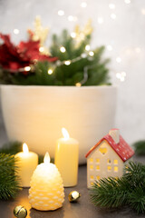 Burning candles on the background of a white basket with branches