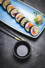 Sushi with tuna, salmon and avocado. Rolls with seafood close-up. Asian food