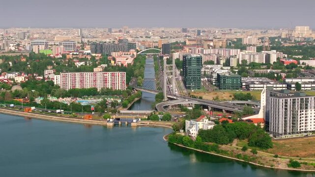 Bucharest from above. Aerial 4K video with Ciurel Bridge and Dambovita River, filmed from Morii Lake. Landmarks and main roads of Bucharest during a summer day.