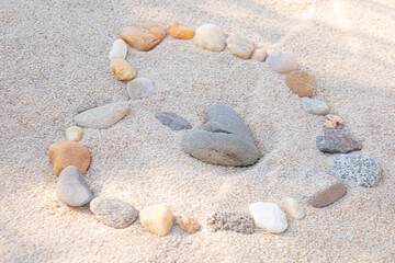 Rocks shaped to make Heart in beach sand 