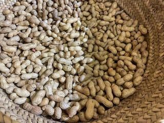 Peanuts in shells in a Woven straw baskets on the display at the local sustainable supermarket
