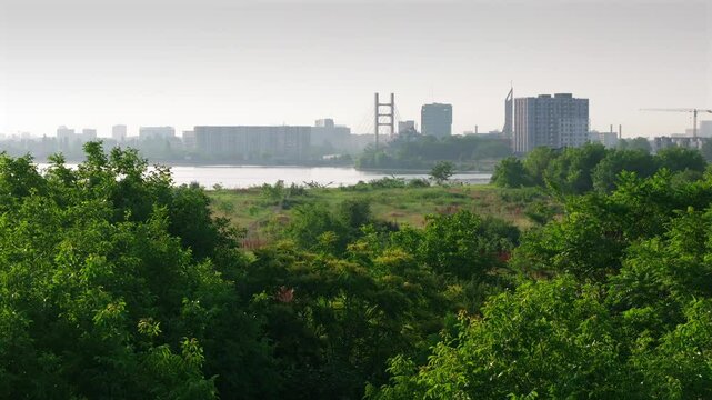 Bucharest from above. Aerial 4K video with Ciurel Bridge and Dambovita River, filmed from Morii Lake. Landmarks and main roads of Bucharest during a summer day.