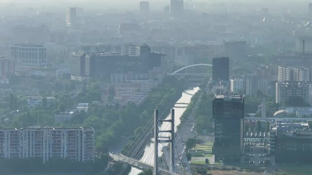Bucharest from above. Aerial 4K video with Ciurel Bridge and Dambovita River, filmed from Morii Lake. Landmarks and main roads of Bucharest during a summer day.