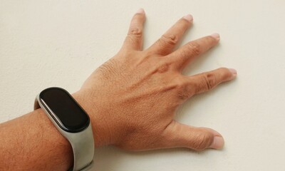 Close up man's arm wearing a smart watch with a white background. Mock up watch for advertising. 