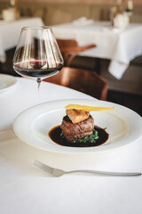 Appetizing steak on a bed of spinach. Foie gras with Madeira sauce