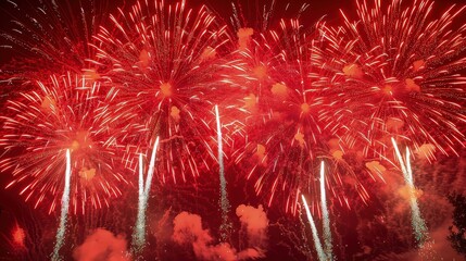 Brilliant red fireworks exploding in a dazzling display, perfect for overlaying on night sky backgrounds.