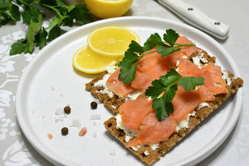 some crisp bread with a slice of salmon and parsley close up 