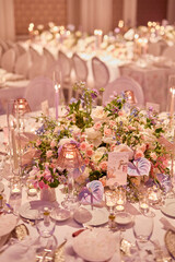 Exquisite Wedding Reception Table Setting with Floral Centerpieces and Candlelight, Creating a Luxurious and Romantic Atmosphere