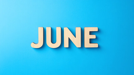 June typography written with wooden letter - new month concept background. 