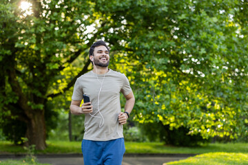 Active man jogging in lush green park with phone and headphones enjoying fitness and healthy lifestyle outdoors