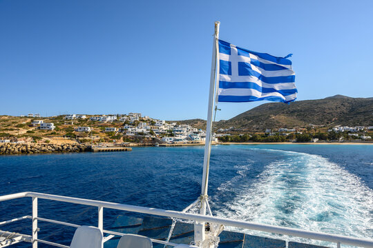 Deck of ferry with Greek flag leaving Donousa island. Cyclades, Greece
