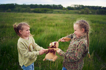 sisters fight over a toy bunny