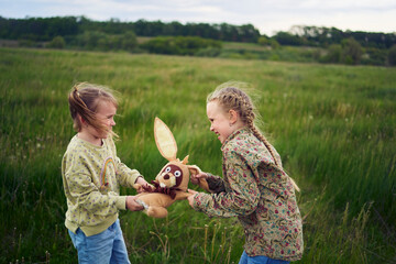 sisters fight over a toy bunny