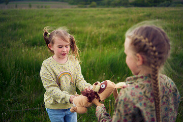 sisters fight over a toy bunny