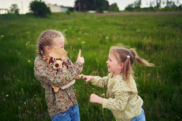 sisters fight over a toy bunny