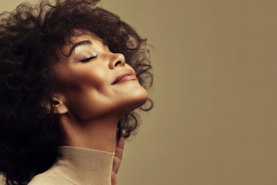 Elegant portrait of a middle-aged African American woman with natural beauty, captured in a minimalistic studio setting, showcasing confidence and grace in a modern and stylish attire.