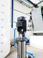 Electric motors for controlling water pumps in industrial plants, power plants and motor line systems. Water pump motors, waste water pipes and water tanks located inside the building