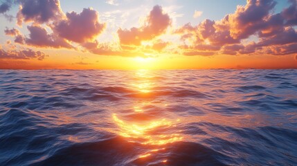 Obraz premium The sun is setting over the ocean, casting a warm glow on the water