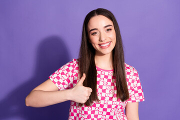 Portrait of nice young woman show thumb up wear checkered t-shirt isolated on violet color background