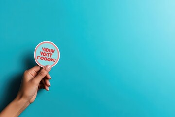 Hand holding a sticker that reads Your Vote Counts, voter motivation, election importance
