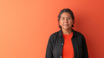 Fototapeta premium Middle aged latin american woman in casual clothing on solid color background