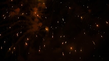 After Explosion Fire Sparks Amber Particles Falling, melting and Glowing in the Smoke