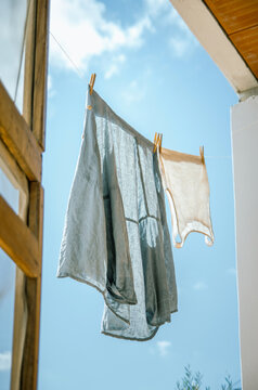 Linen shirt and top air drying on a clothesline in the sun