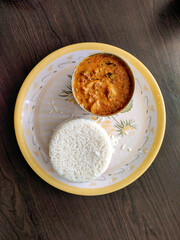 Aromatic and flavorful moth bean sprouts curry or Molake Kalu Saaru, served with a generous portion of fluffy white rice. Visually appealing dish.